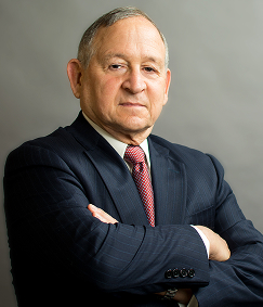 Portrait of Bernard Dane Stein, tax attorney in a suit with arms crossed